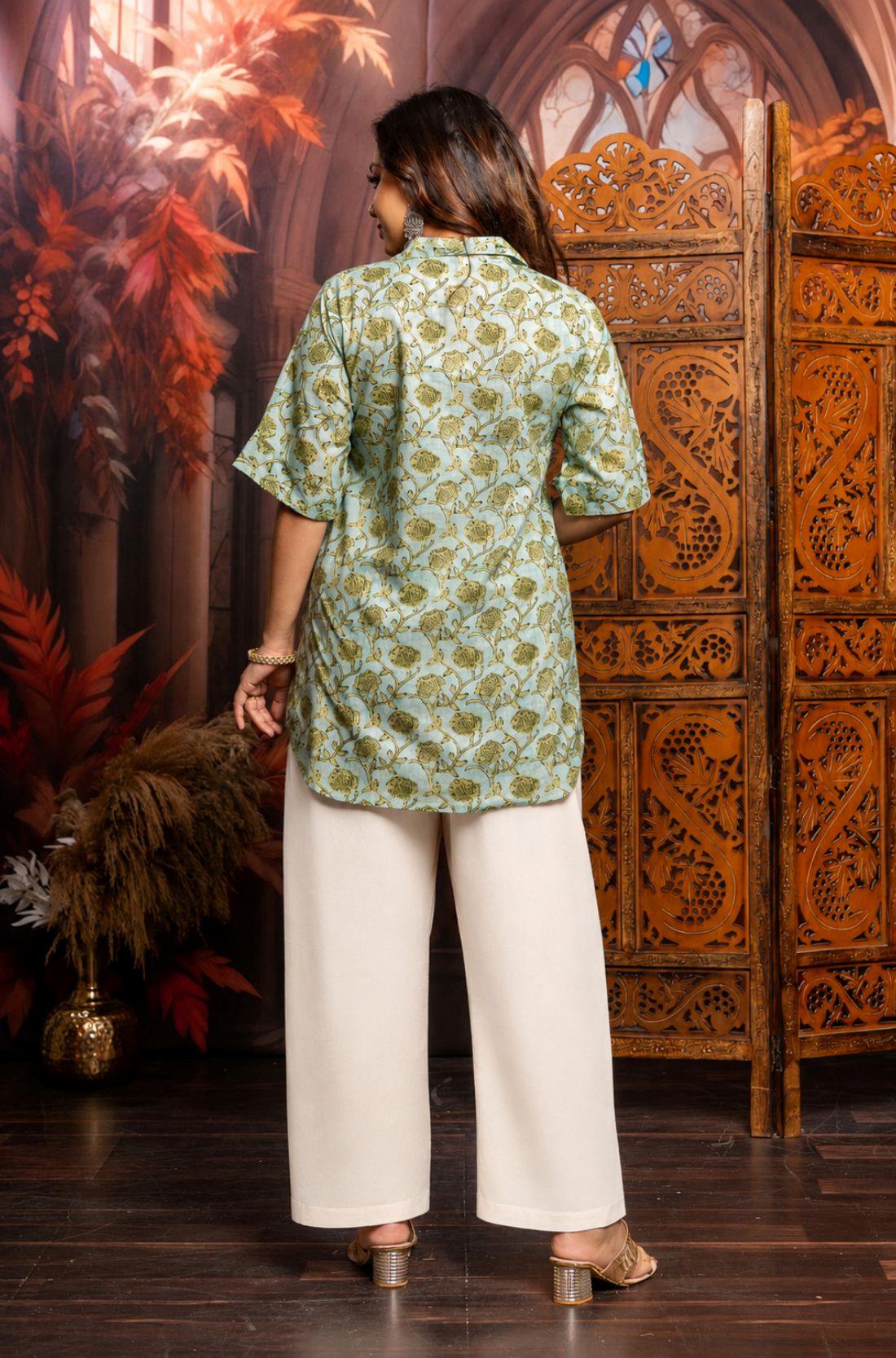 Back View
Back view of a women's mint green block print cotton short kurti featuring short sleeves and curved hem.