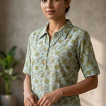 Front close-up of a women's mint green floral block print cotton shirt with wooden buttons and classic collar.