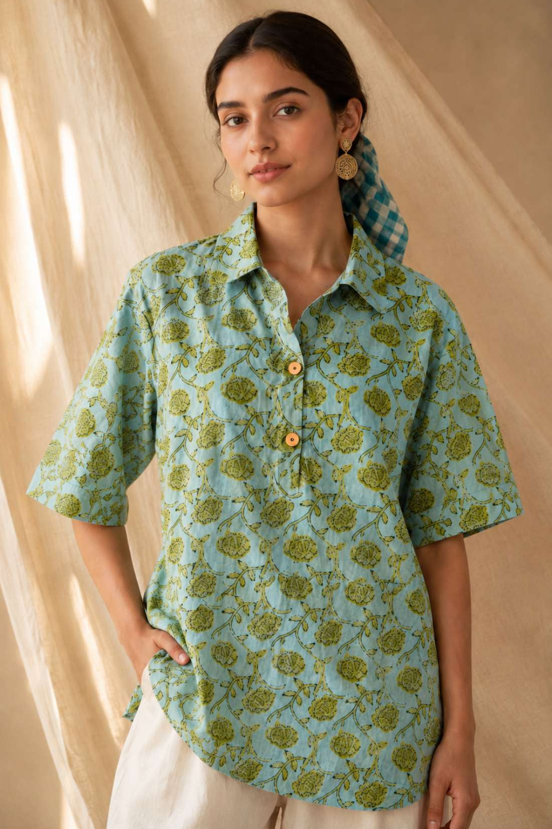 Front close-up of a women's mint green floral block print cotton shirt with wooden buttons and classic collar.