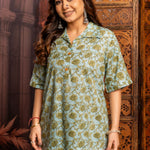 Front close-up of a women's mint green floral block print cotton short kurti with wooden buttons and classic collar.