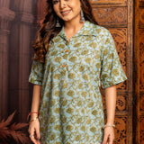 Front close-up of a women's mint green floral block print cotton short kurti with wooden buttons and classic collar.