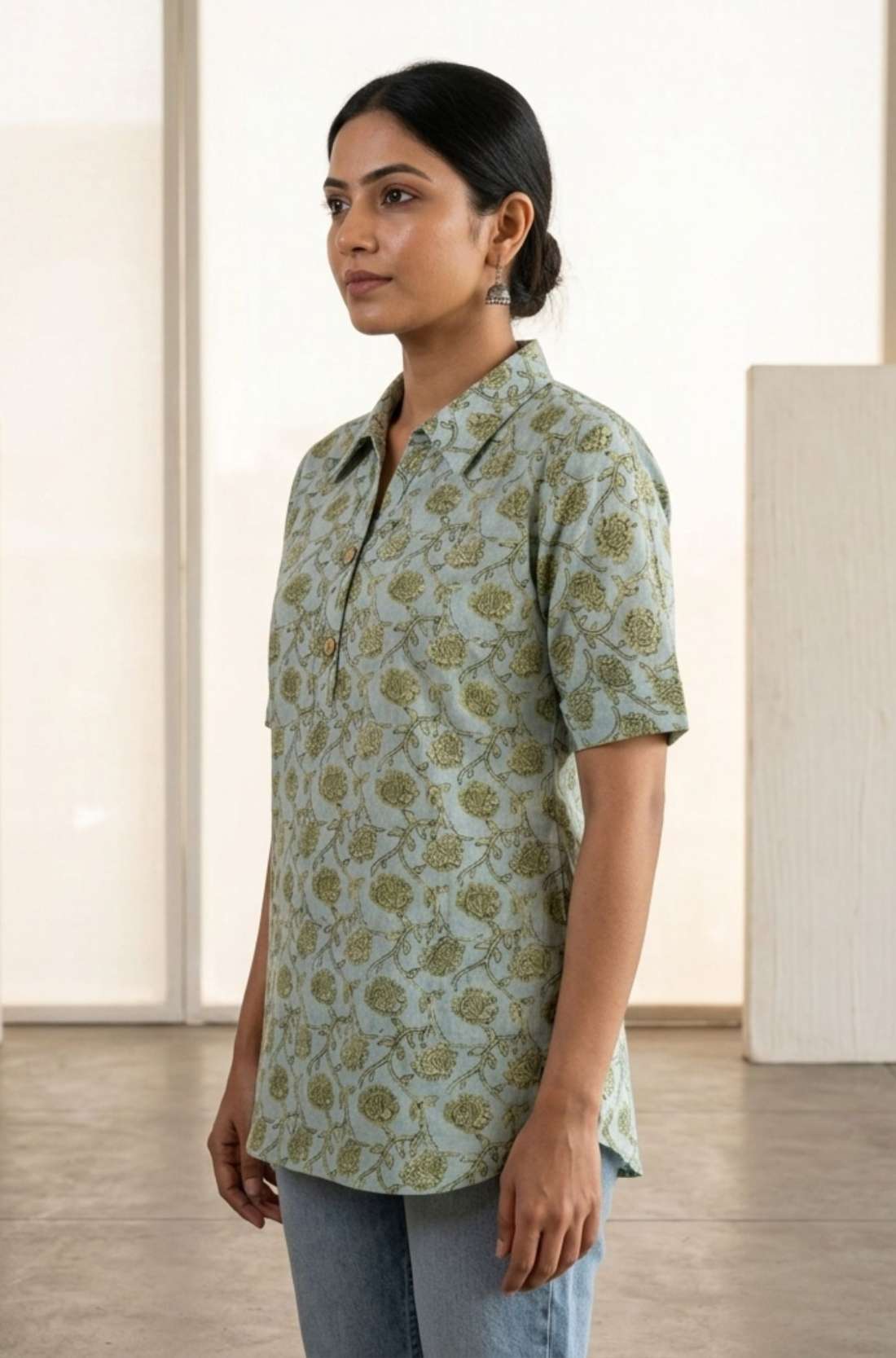 Side view of a women's mint green hand block print cotton shirt with short sleeves, collared neckline, and relaxed fit.