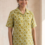 Front view of a women's yellow hand block print cotton shirt with wooden buttons and short sleeves.
