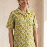 Front view of a women's yellow hand block print cotton shirt with wooden buttons and short sleeves.