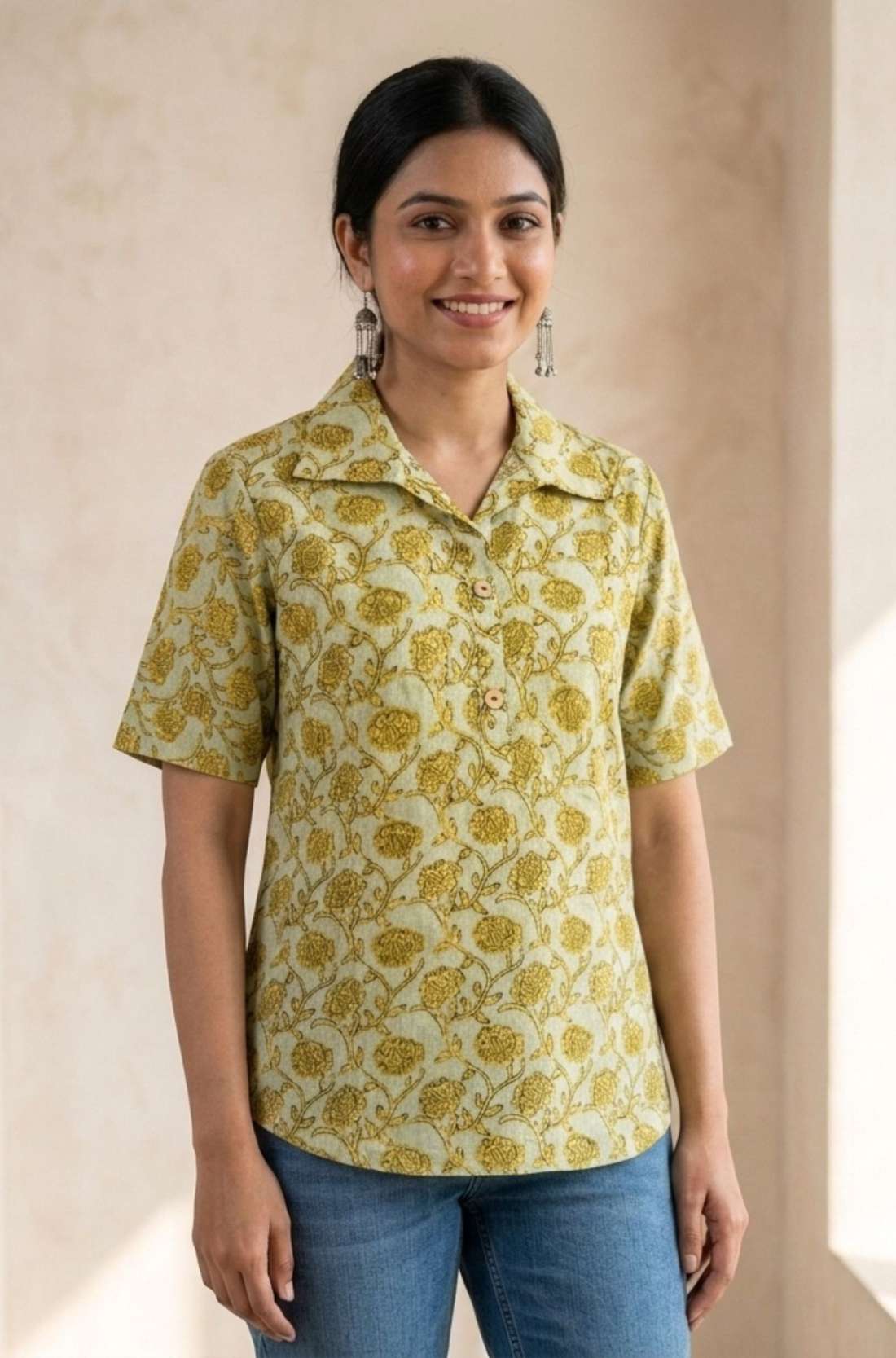 Front view of a women's yellow hand block print cotton shirt with wooden buttons and short sleeves.