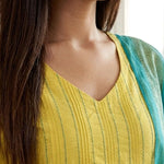 Close up shot of the V neckline showing the vertical pink thread embroidery lines and fine stitch work on the yellow cotton kurta