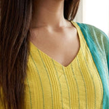 Close up shot of the V neckline showing the vertical pink thread embroidery lines and fine stitch work on the yellow cotton kurta
