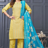 Side profile view of a model in a yellow cotton ethnic suit set displaying the straight-cut pants silhouette and the beautiful pattern of the draped matching dupatta